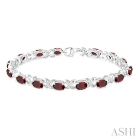 7x5  MM Oval Cut Garnet and 1/20 Ctw Round Cut Diamond Fashion Bracelet in Sterling Silver
